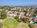 Aerial view of Southern California houses surrounded by golf in inland town Corona