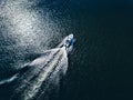 Aerial view of speed Boat or yacht at blue sea or lake leaving a wake Royalty Free Stock Photo