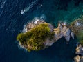 Aerial view of a speedboat hurtling near the island of Sveti Nikola, island of Budva, Montenegro. Jagged coasts Royalty Free Stock Photo