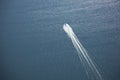 Aerial view of speedboat leaving white wake on a lake