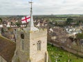 Aerial view of a St Georges English nation flag seen atop on English village church tower.