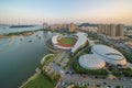 Aerial view of the stadium and city beside the sea, urban skyline with sunset landscapes in Xiamen, Fujian, China