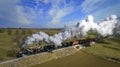 Aerial View of a Steam Double-Header Freight , Passenger Train Approaching Blowing Lots of Smoke