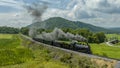 Aerial View of a Steam Narrow Gauge Passenger Train Approaching Runk Rd. Bridge