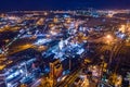 Aerial view of steel plant at night with smokestacks and fire blazing out of pipe. Industrial panoramic landmark with blast Royalty Free Stock Photo