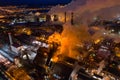 Aerial view of steel plant at night with smokestacks and fire blazing out of the pipe. Industrial panoramic landmark with blast Royalty Free Stock Photo