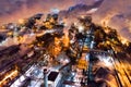 Aerial view of steel plant at night with smokestacks and fire blazing out of pipe. Industrial panoramic landmark with blast Royalty Free Stock Photo