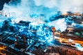 Aerial view of steel plant at night with smokestacks and fire blazing out of the pipe. Industrial panoramic landmark w Royalty Free Stock Photo