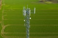 Aerial view on steel telecommunication tower in the middle of green field transmitting radio, telephone and internet signal Royalty Free Stock Photo