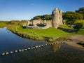 Aerial view of stepping stones over a small river leading to the ruins of an ancient castle Ogmore Castle, Wales Royalty Free Stock Photo