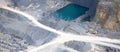 Aerial view : Stone quarry with a turquoise pond Royalty Free Stock Photo