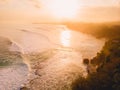 Aerial view of stormy waves at warm sunrise and sandy beach. Biggest ocean wave in Bali Royalty Free Stock Photo
