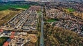 Aerial view of a suburban housing development with rows of houses, contrasting undeveloped land, and streets in Harrogate, North Royalty Free Stock Photo