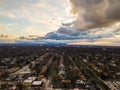 Aerial view of suburbs pointing to downtown Cleveland in the far distance, the spring clouds a splash of color across the top of t