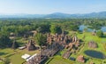 Aerial view of Sukhothai Historical Park, buddha pagoda stupa in a temple, Sukhothai, Thailand with green mountain hills and