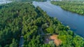 Aerial view summer forest and river in sunny day. Drone shot beautiful nature Royalty Free Stock Photo