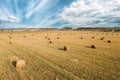 Aerial View Of Summer Hay Rolls Straw Field Landscape. Haystack, Hay Roll In Summer Sunny Day. Bright Blue Sky Above Royalty Free Stock Photo
