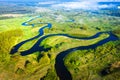 Aerial view on summer river. River stream on green meadow. Summer nature landscape. Drone view on riverside