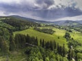 Aerial view of the summer time in mountains near Stronie Slaskie town in Poland. Pine tree forest and clouds over blue sky. View Royalty Free Stock Photo