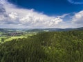 Aerial view of the summer time in mountains near Stronie Slaskie town in Poland. Pine tree forest and clouds over blue sky. View Royalty Free Stock Photo