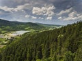 Aerial view of the summer time in mountains near Stronie Slaskie town in Poland. Pine tree forest and clouds over blue sky. View Royalty Free Stock Photo