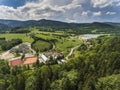 Aerial view of the summer time in mountains near Stronie Slaskie town in Poland. Pine tree forest and clouds over blue sky. View Royalty Free Stock Photo