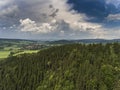 Aerial view of the summer time in mountains near Stronie Slaskie town in Poland. Pine tree forest and clouds over blue sky. View Royalty Free Stock Photo