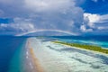 Tranquil beach landscape, palm trees, luxury villas, sand, sea. Rainbow over cloudy horizon Royalty Free Stock Photo