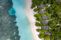 Aerial bird\'s eye drone view of a beautiful tropical vacation beach with crystal clear blue water, white sand, palm trees Royalty Free Stock Photo