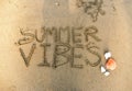 Aerial view summer vibes written in the sand