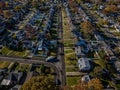 Aerial view of a sunny residential neighborhood featuring repaved roads with construction vehicles. Royalty Free Stock Photo