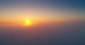 Aerial view of sunrise above the clouds. Drone flight in heavens.