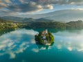 Aerial view of sunrise at Bled lake, Slovenia. Flying around island with Church of the Assumption of Mary in Bled lake Royalty Free Stock Photo