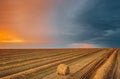 Aerial View Of Sunset Bright Sky Above Summer Hay Field Landscape In Evening. Haystack, Hay Roll in Sunrise time Royalty Free Stock Photo