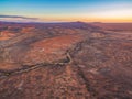 Aerial view of sunset over alien martian-like red landscape. Royalty Free Stock Photo