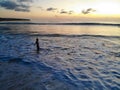 Aerial view of sunset over the sea with woman looking at the view, Bali, Indonesia. Royalty Free Stock Photo