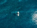 Aerial view of surfer in blue ocean. Top view. Surfing in sea Royalty Free Stock Photo