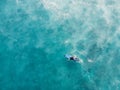 Aerial view of surfer on longboard in ocean with foam after wave. Top view Royalty Free Stock Photo
