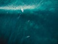 Aerial view with surfers and barrel wave in tropical blue ocean. Top view Royalty Free Stock Photo