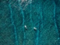 Aerial view of surfers in ocean. Top view. Surfing in tropical sea Royalty Free Stock Photo