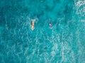 Aerial view of surfers and wave in blue clear ocean. Top view Royalty Free Stock Photo