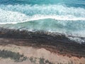 Aerial view of surfers in the waves of the  Atlantic ocean. Sandy beach. Panorama background shot on a drone. Selectivity focus Royalty Free Stock Photo
