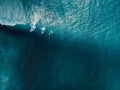 Aerial view of surfing at perfect barrel waves. Blue waves and surfers in ocean Royalty Free Stock Photo