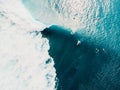 Aerial view of surfing at perfect barrel waves. Blue waves and surfers in ocean Royalty Free Stock Photo