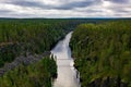 Aerial view of a suspension bridge crossing a canyon lake in forest Royalty Free Stock Photo