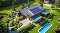 Aerial View of a Sustainable Modern Luxury Home with solar panels and big lawn with trees, concept of eco friendly house