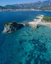 Aerial view of Sveti Nicola, Budva island, Montenegro. Hawaii beach, umbrellas and bathers and crystal clear waters