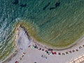 Aerial view of Sveti Nicola, Budva island, Montenegro. Hawaii beach, umbrellas and bathers and crystal clear waters