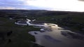 Aerial view of a swampy terrain on a sunset sky background. Clip. Bending river and fields. Royalty Free Stock Photo