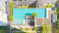 Aerial view of swimming pool on rooftop of hotel apartment building in Bangkok downtown skyline, urban city view. Relaxing in